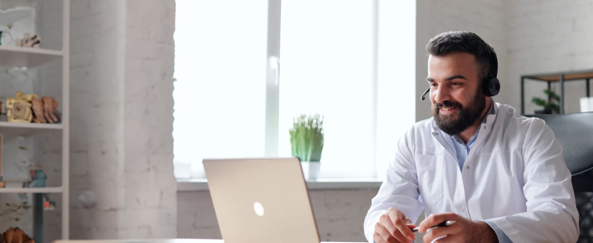 Man with headset using laptop
