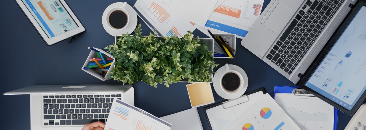 Busy work desk with devices