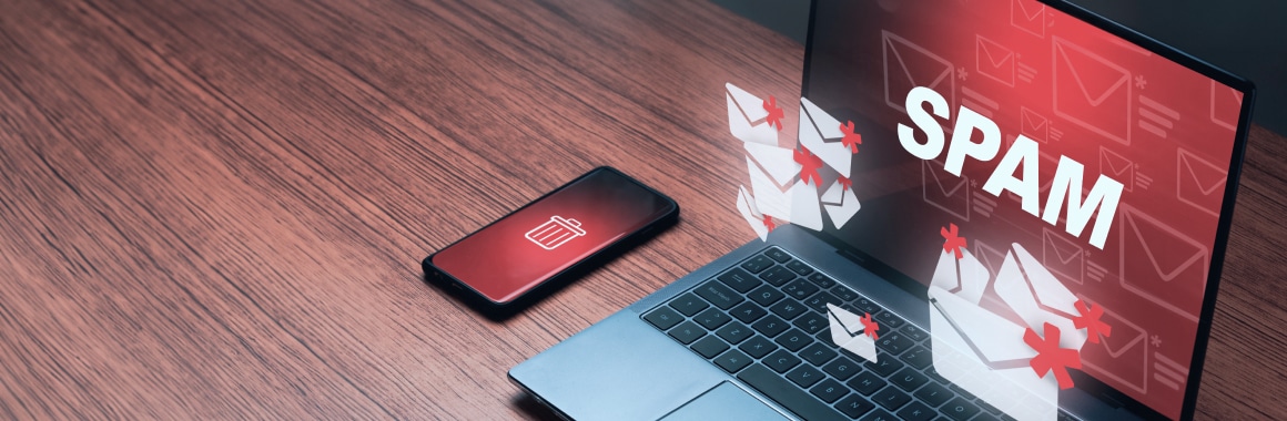 Laptop and phone with spam alert