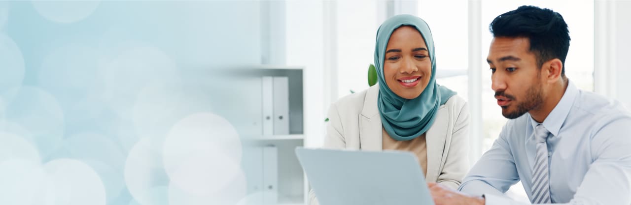two people looking at a computer