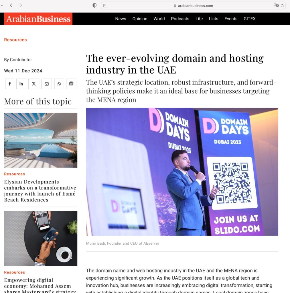 Munir Badr holding mic and speaking at Domain Days Dubai event.